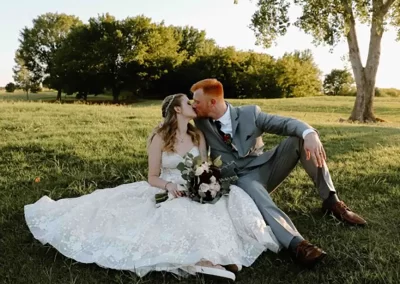 Bride and Groom Kiss Sitting