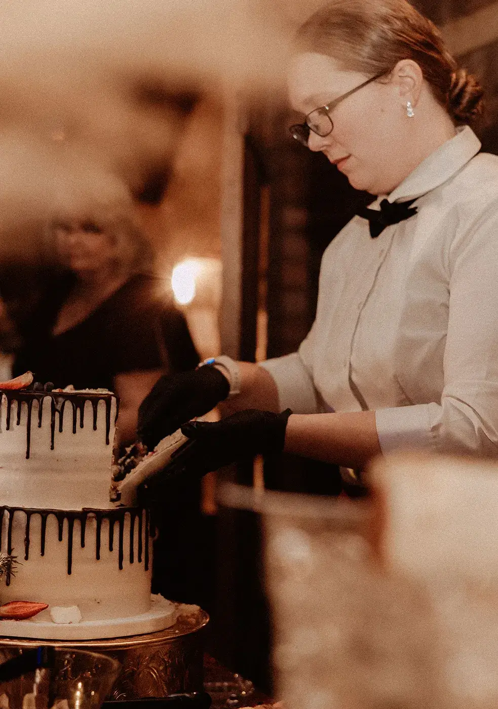 Venue Coordinator and Full Staff Venue staff member cutting cake during reception