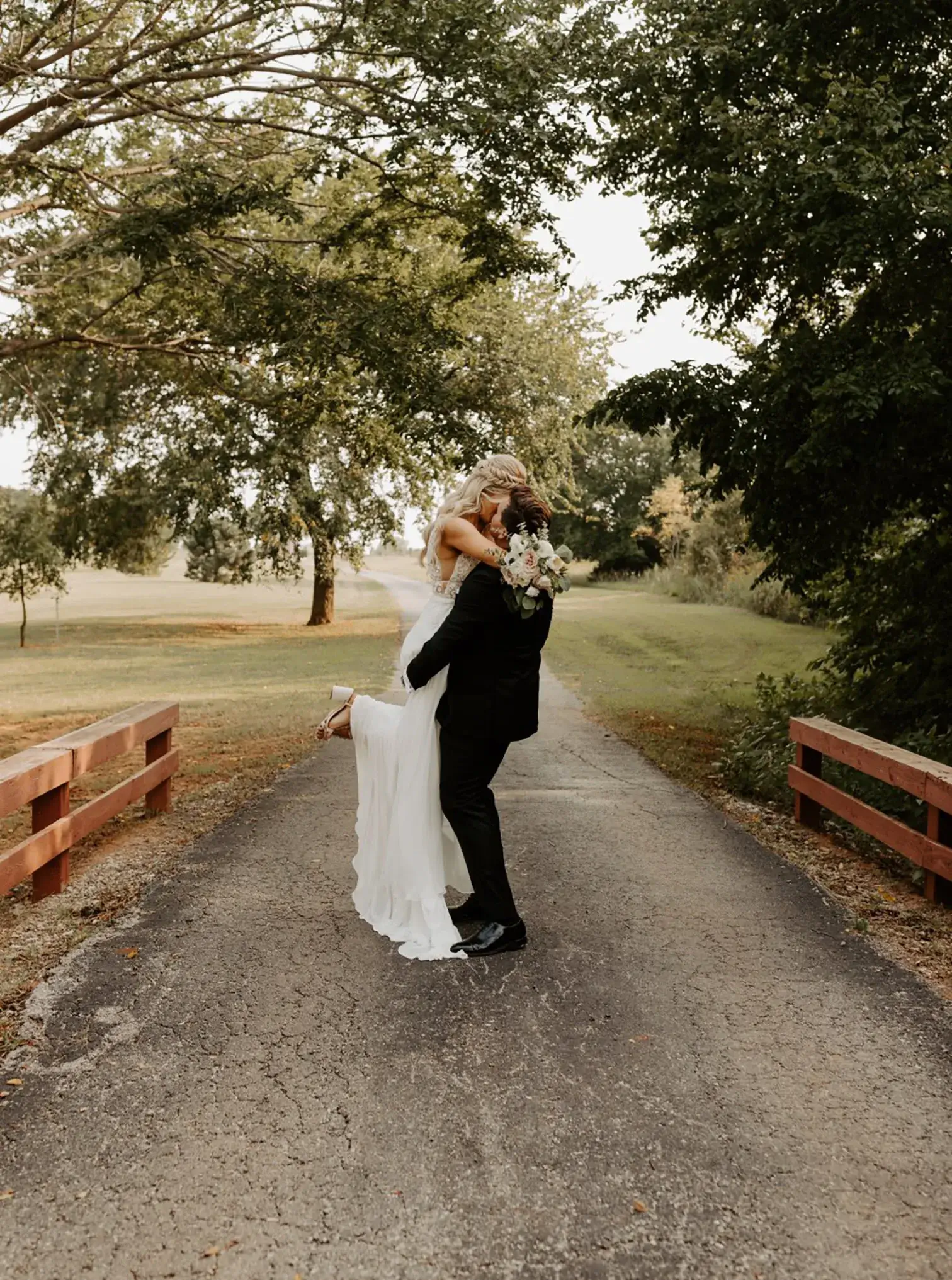 full-service-wedding-package-couple-kiss A groom lifting his bride in the air and kissing her