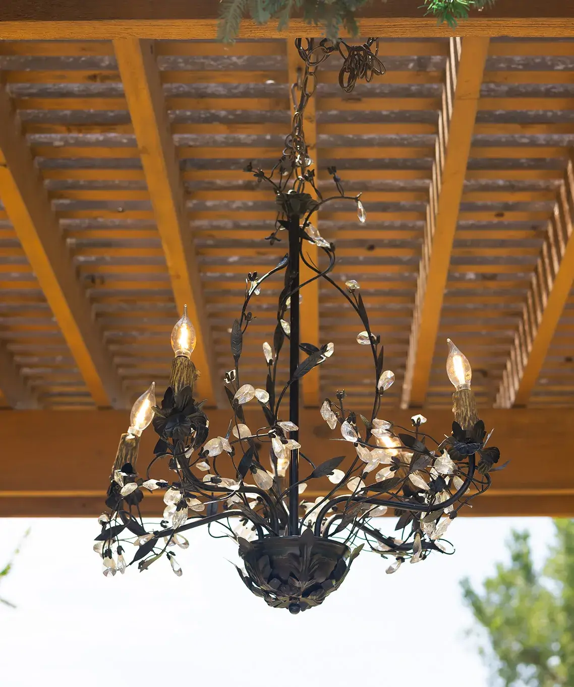 Chandelier hanging from pergola