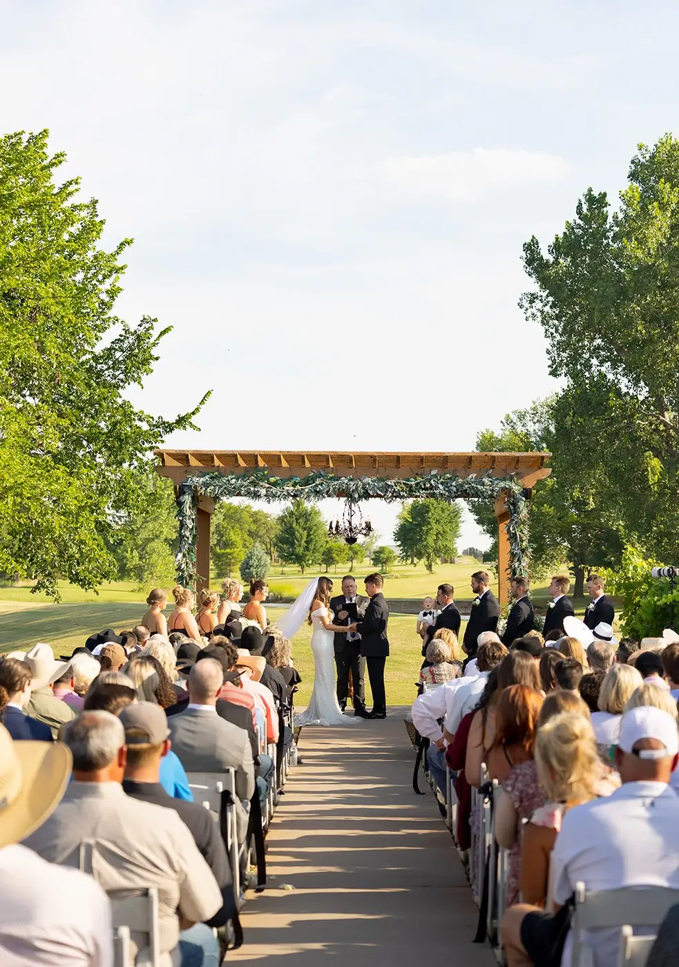 Spring Weddings Ceremony under the pergola at our outdoor wedding venues in Oklahoma