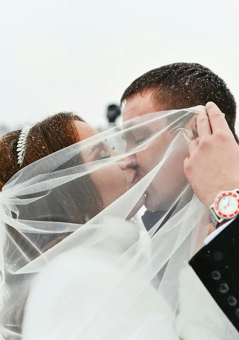 Winter Weddings Bride and groom kissing in the snow