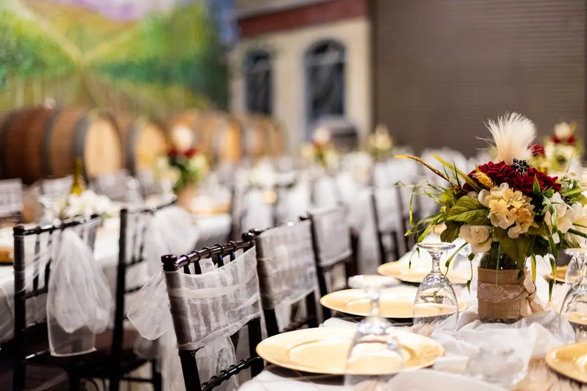 Wedding pergola with fall florals and wine barrels